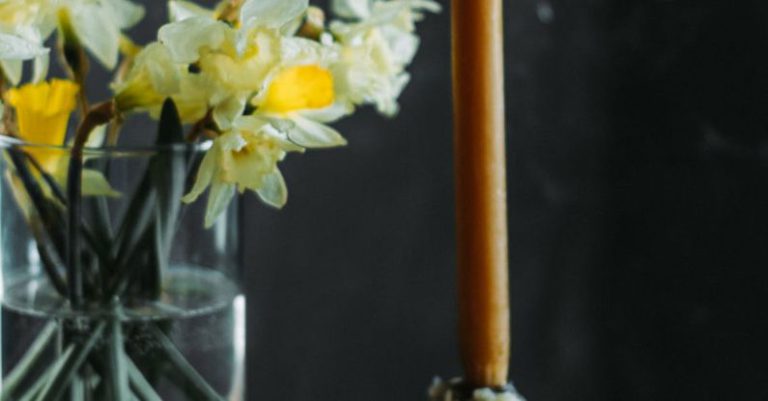 Setting Priorities - Easter eggs and candle on table near flowers in vase