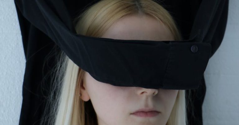 Mindful Decision Making - Unrecognizable blindfolded woman with tattoo on chest