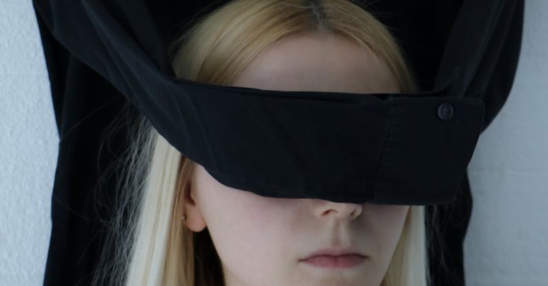 Mindful Decision Making - Unrecognizable blindfolded woman with tattoo on chest