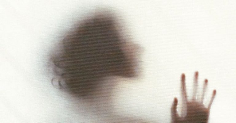 Daily Inspiration - Silhouette of sensual dreamy anonymous female standing behind window and touching glass