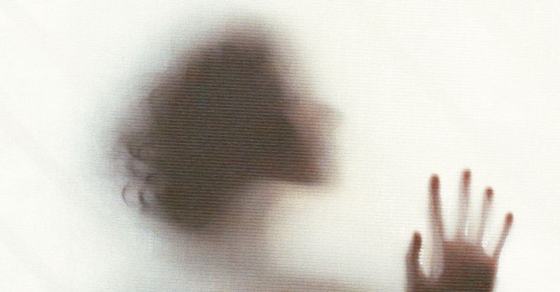 Daily Inspiration - Silhouette of sensual dreamy anonymous female standing behind window and touching glass