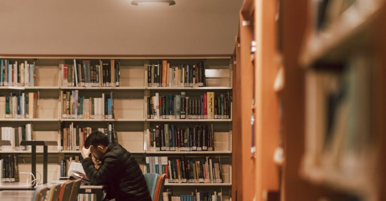 Maintaining Focus - A person sitting at a table in a library