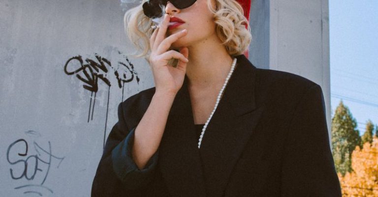 Building Habits - Lady with cigarette near building in street