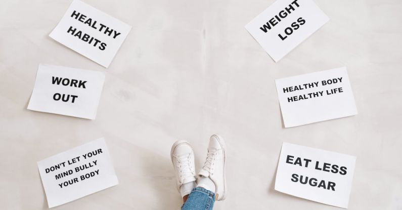 Consistent Habits - Person Legs with Motivational Words on Papers on White Background