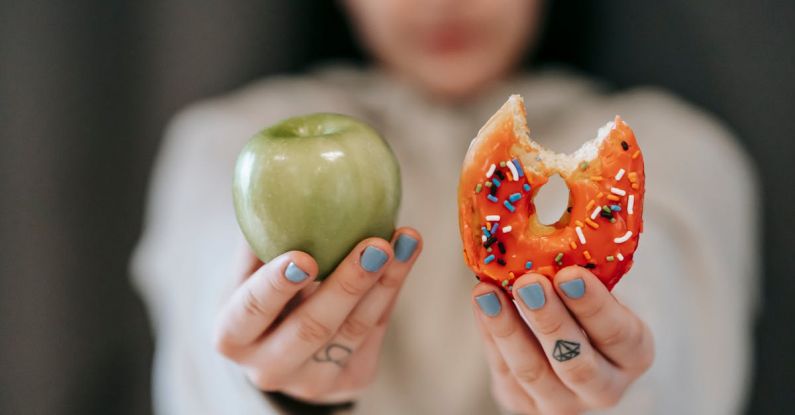 Habit Challenges - Woman showing apple and bitten doughnut