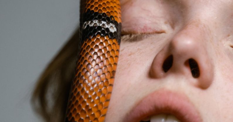 Overcoming Lack - Close-Up Photo of a Woman Overcoming Her Fear of Snakes