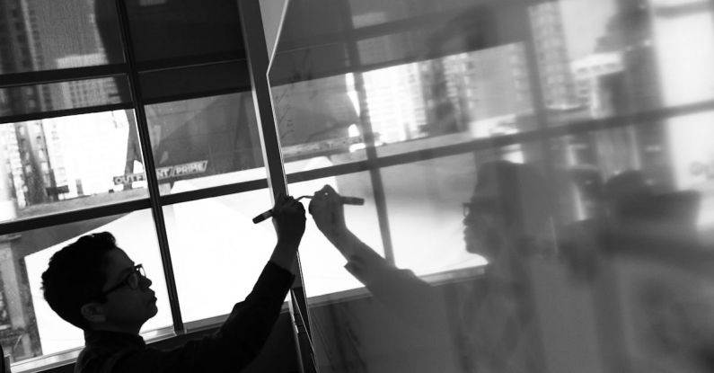 Reflective Planning - Grayscale Photo of Man Holding Pen